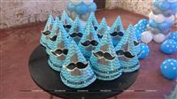 Moustache themed hats personalised with the baby name set on a table for kids.